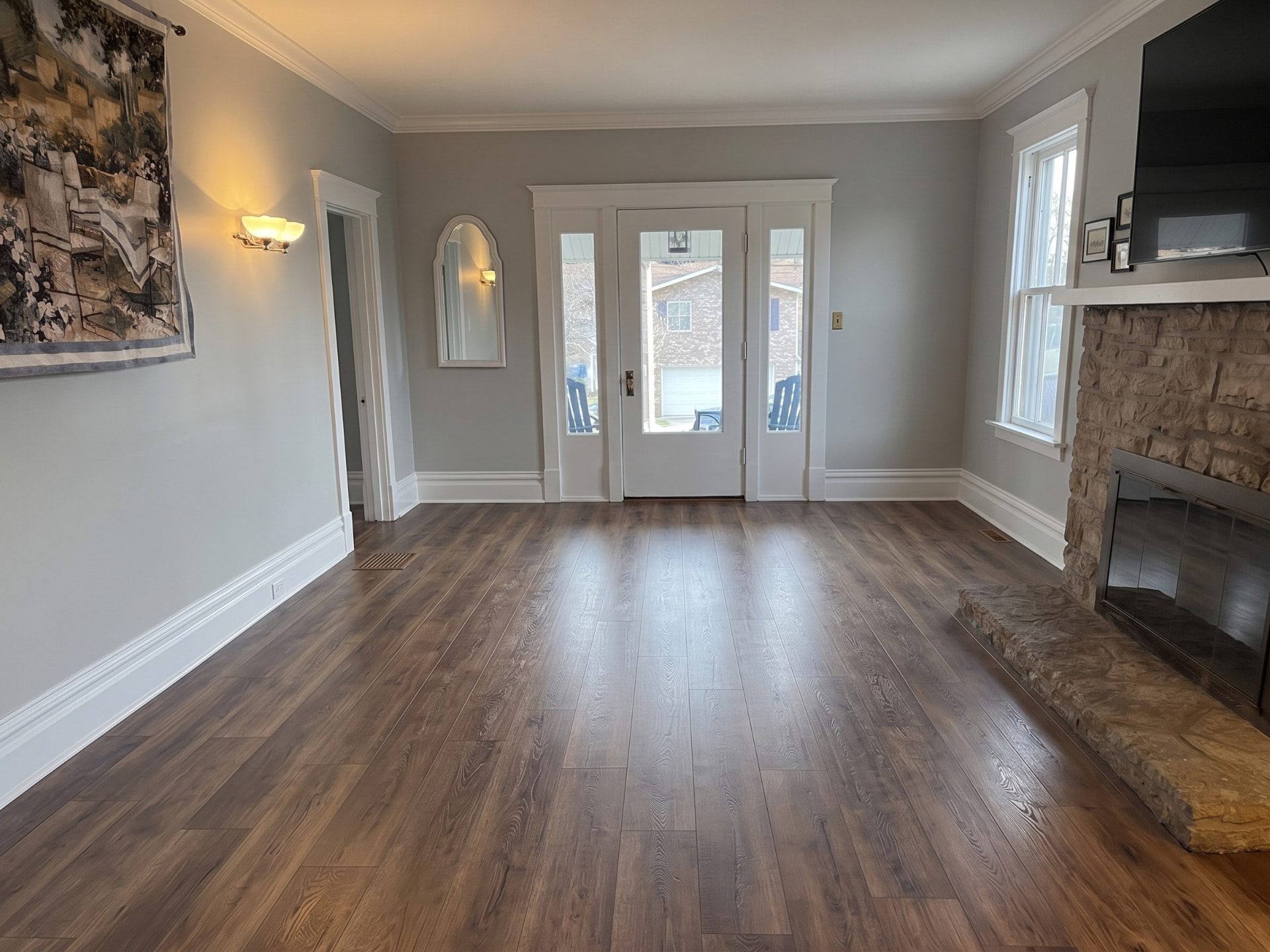 Completed walnut-tone vinyl plank flooring in a living room