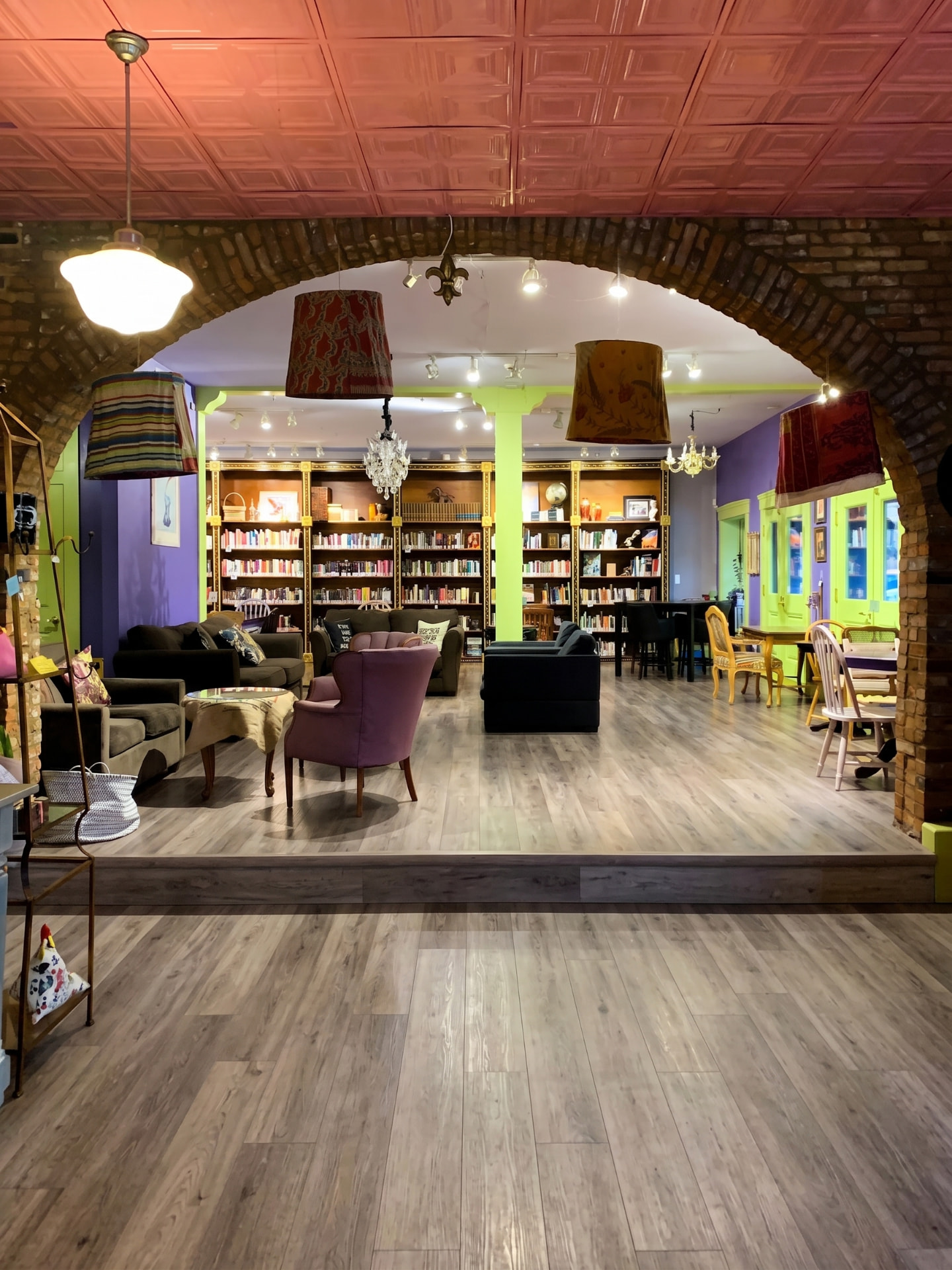 Commercial vinyl plank flooring installation in a bookstore and lounge with brick archways